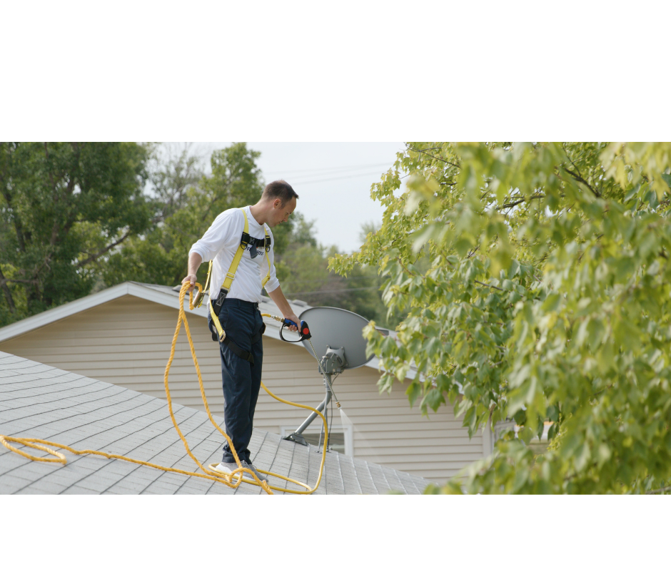 Certified technician harnessed in for safety while treating a residential roof